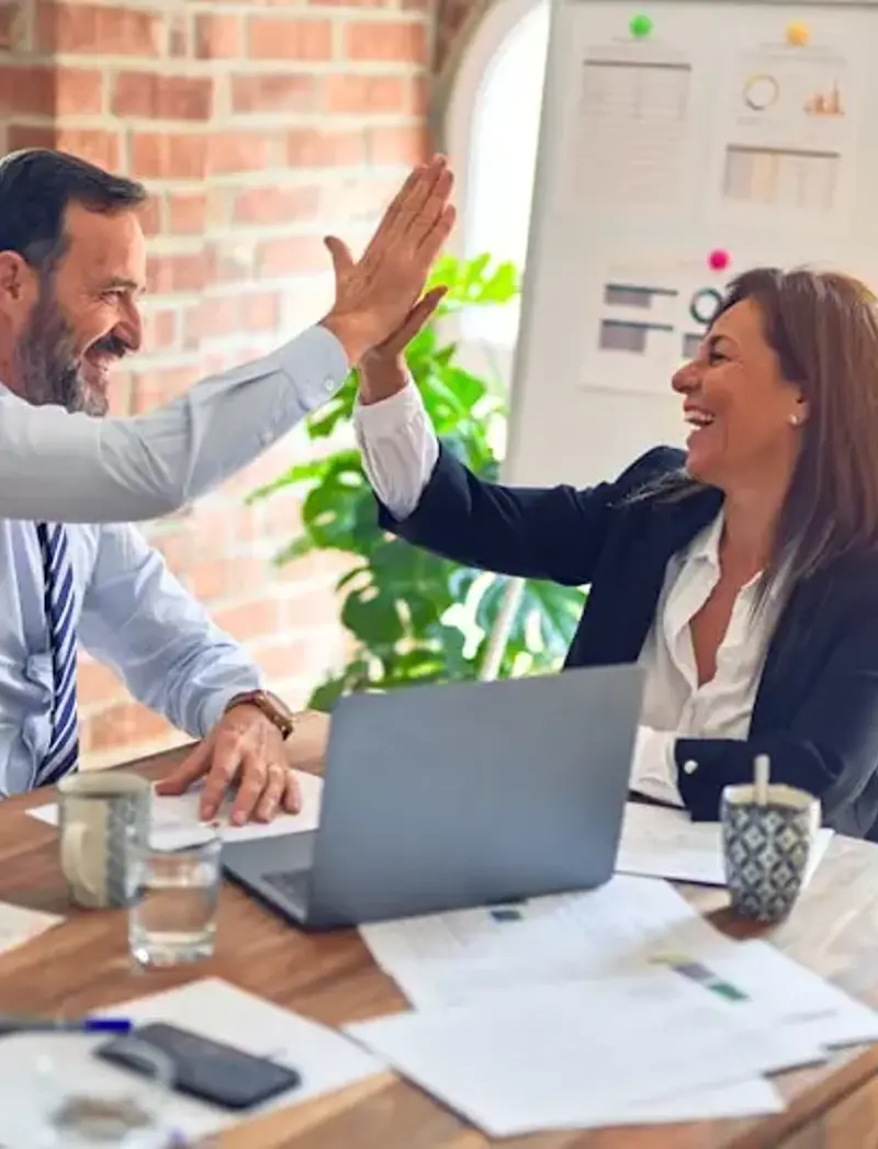 two business people hi fiving